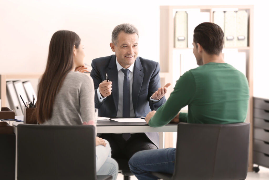 Young couple at notary public office Accountant consulting clients